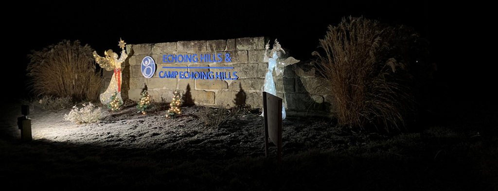 Picture of the rock with Echoing Hills and Camp Echoing Hills Logos surrounded by Christmas Angles
