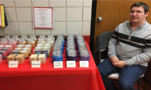 Michael at a craft show selling the candles he makes