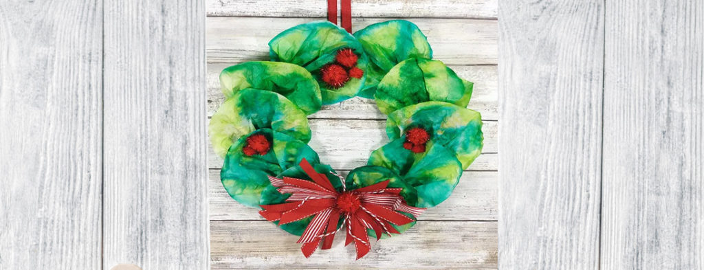 Red and green wreath with a red bow made from Coffee Filters.