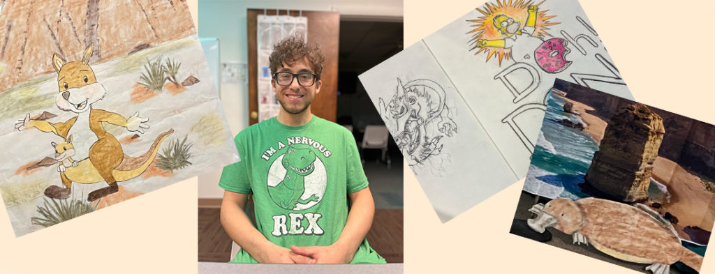 Picture of Eli in a green tshirt surrounded by his artwork. A kangaroo, platypus, dragon and simpsons. Smiling and happy, Eli wears glasses.
