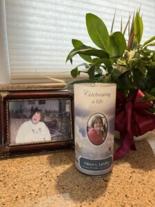 Picture of a memory candle and a photo of Valerie that lived at echoing hills.