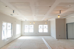 Large gathering space with drywall taped and mudded.