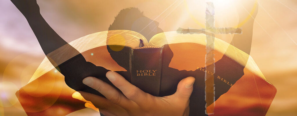 Photo of a man praising God, holding the Bible, with an opaque cross in the background.